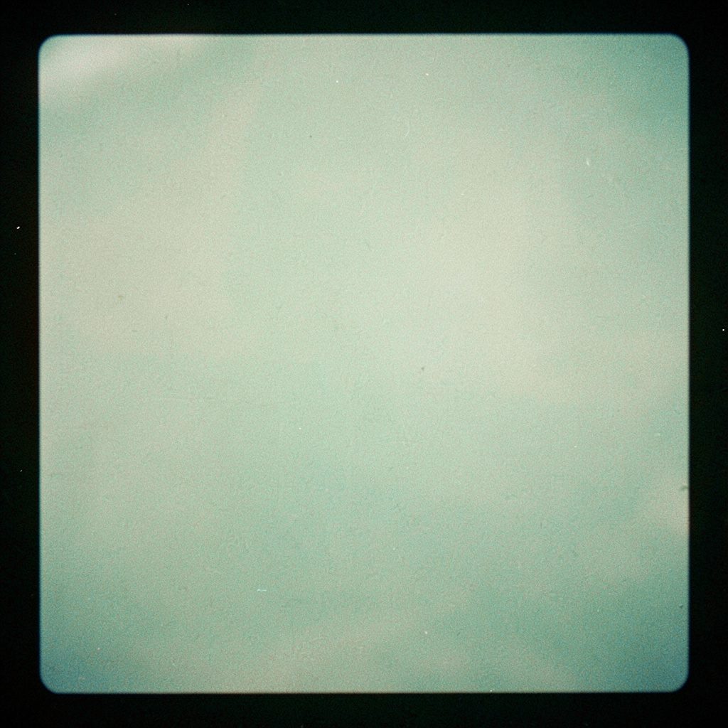 Small square logo graphic in muted tones
